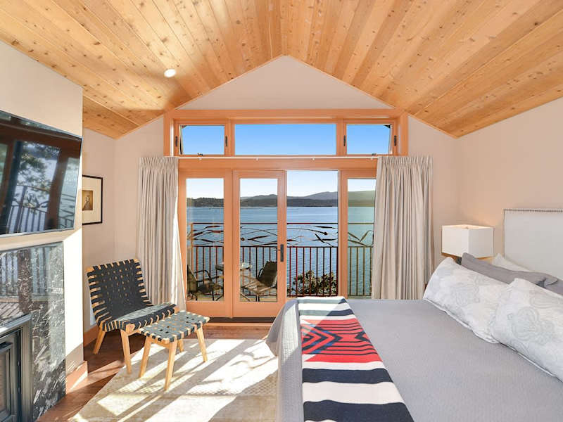 Primary bedroom with private balcony and sweeping bay views.