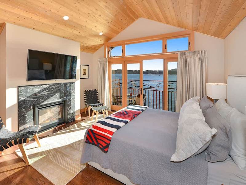 Primary bedroom with private balcony and sweeping bay views.