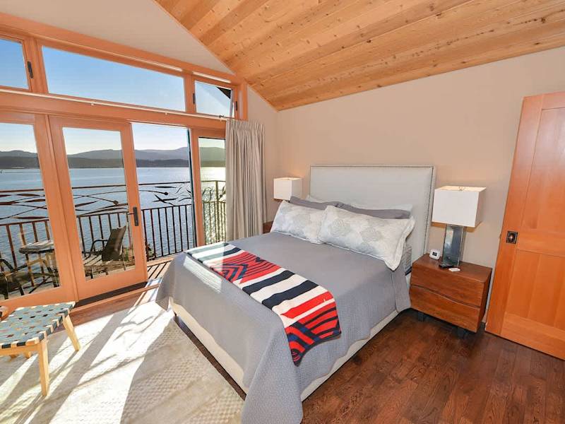 Primary bedroom with private balcony and sweeping bay views.