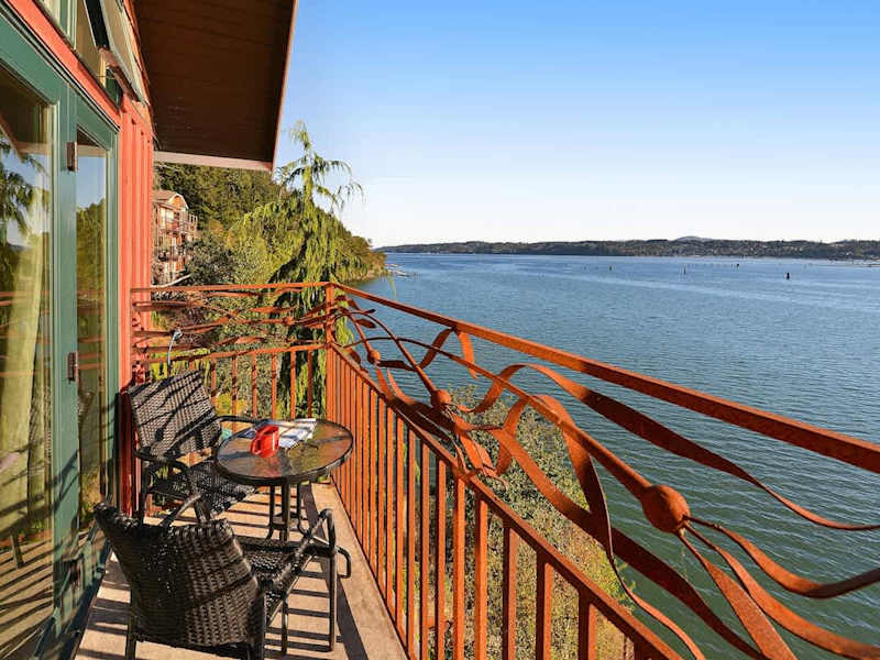 Primary bedroom private bay view balcony.