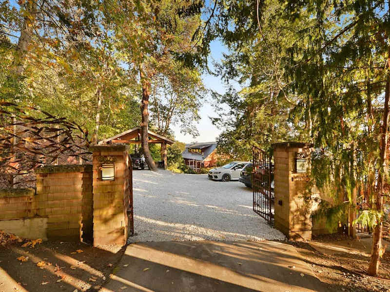 Main gates to the property with secure parking to the right.