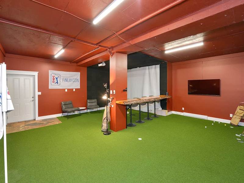 Indoor golf putting room on the lower floor.