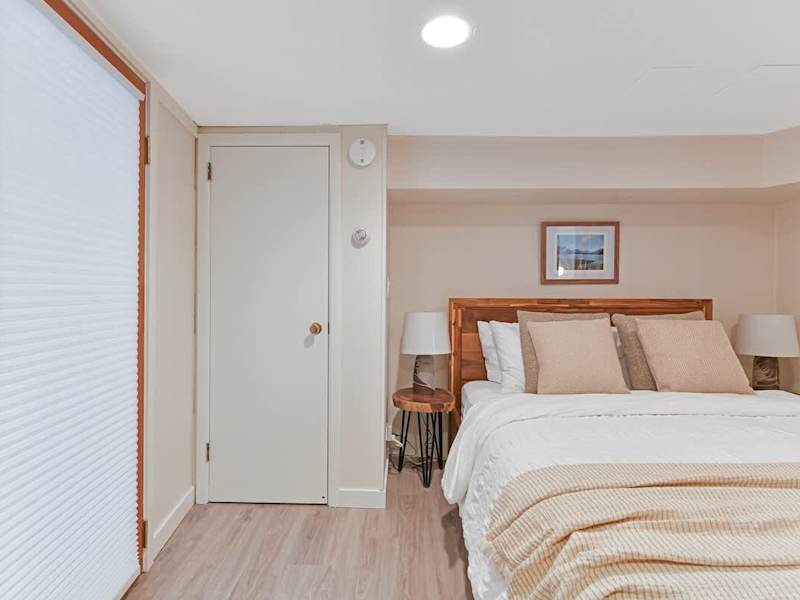 Den that acts as a second bedroom with queen bed.