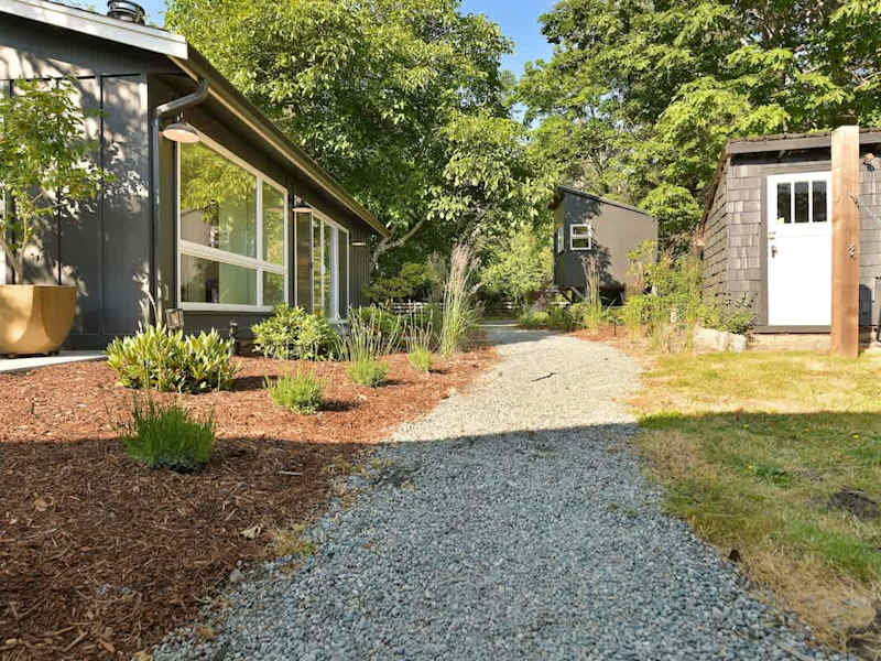 Backyard path between the third bedroom cottage.
