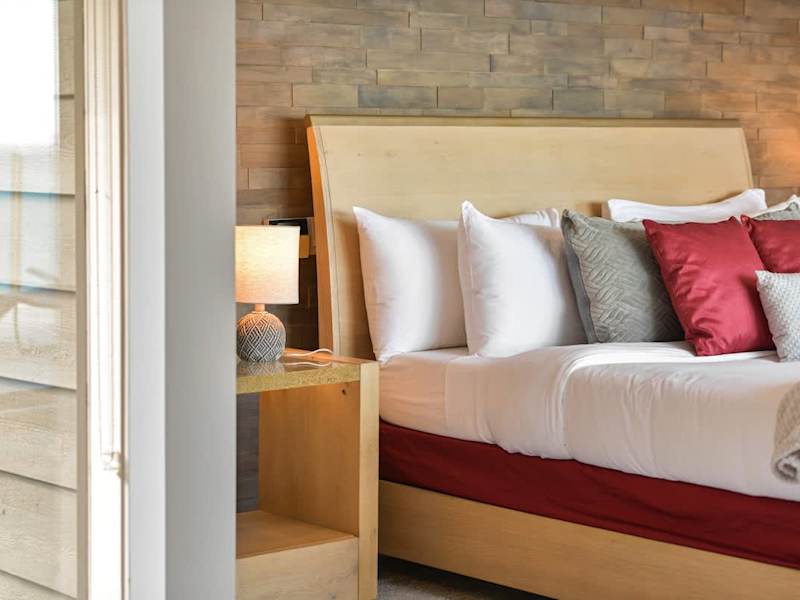 Primary bedroom suite on the top floor with king bed, private deck, living room and full ensuite with walk in closet.