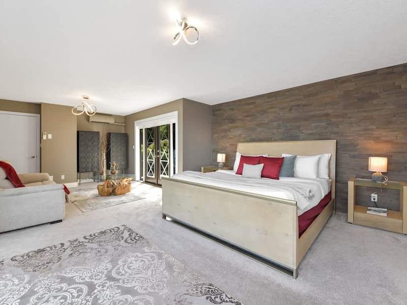 Primary bedroom suite on the top floor with king bed, private deck, living room and full ensuite with walk in closet.