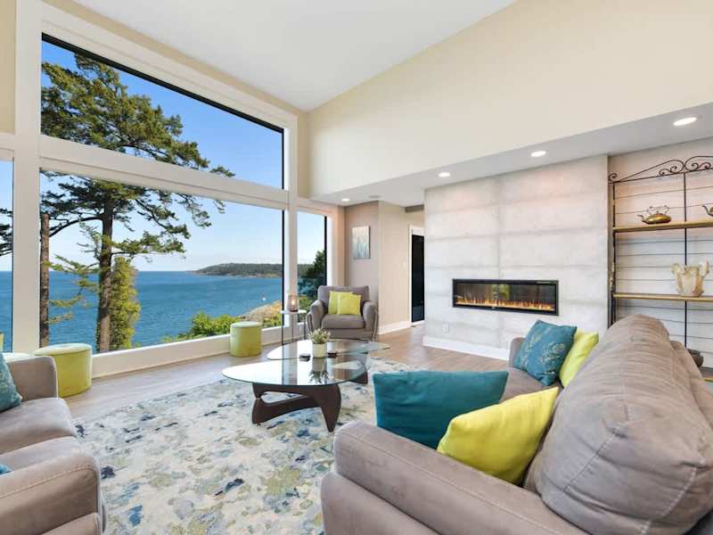 Main floor well appointed living room with spectacular views of the ocean and islands.