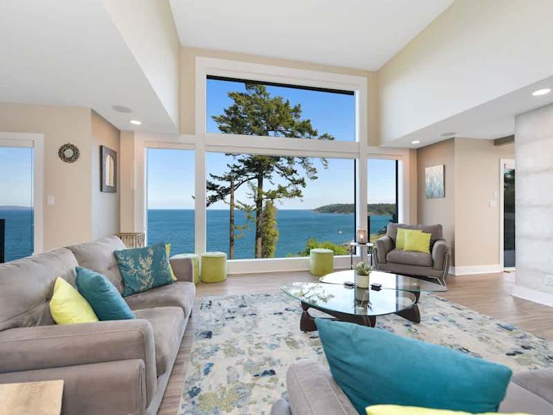 Main floor well appointed living room with spectacular views of the ocean and islands.
