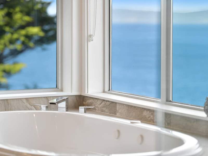 Primary bedroom suite on the top floor with king bed, private deck, living room and full ensuite with walk in closet.