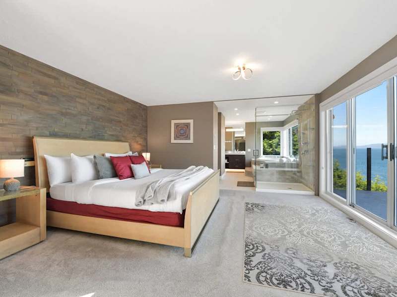 Primary bedroom suite on the top floor with king bed, private deck, living room and full ensuite with walk in closet.