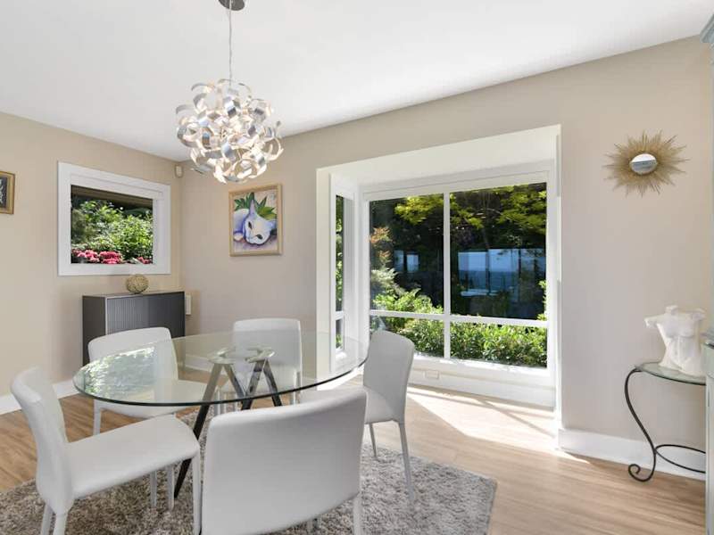 Second dining table space on the main floor with both garden and ocean views.