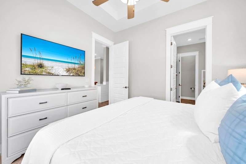Primary bedroom features smart tv.
