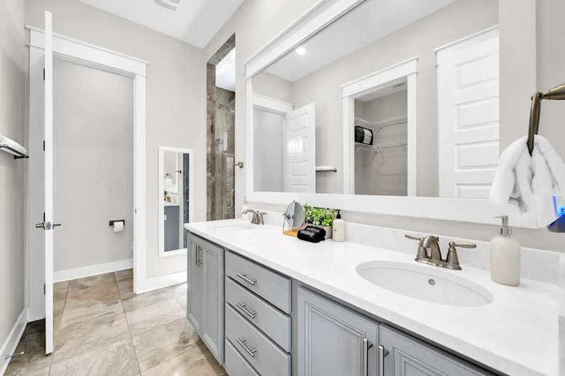 Primary bathroom featuring a large walk-in closet and large shower.