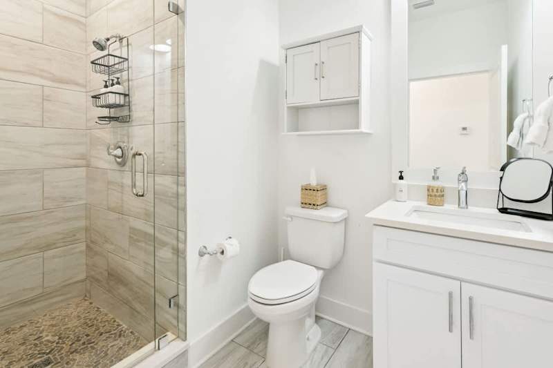 Loft bathroom with vanity and walk-in shower.