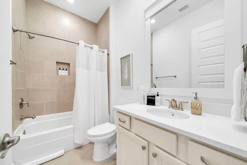 Guest bathroom features a shower/tub combo.