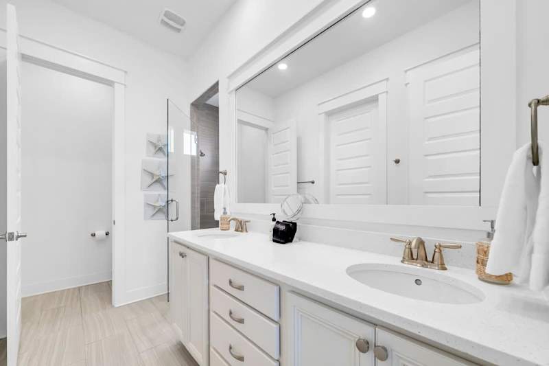Primary bathroom features a large walk-in closet, dual vanities and a large walk-in shower.