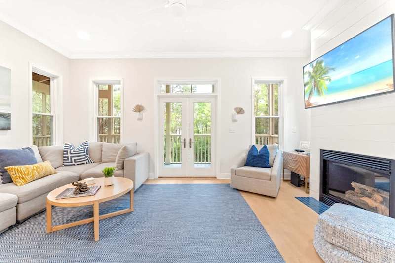 Spacious living room on the second floor with wraparound screened-in balcony.