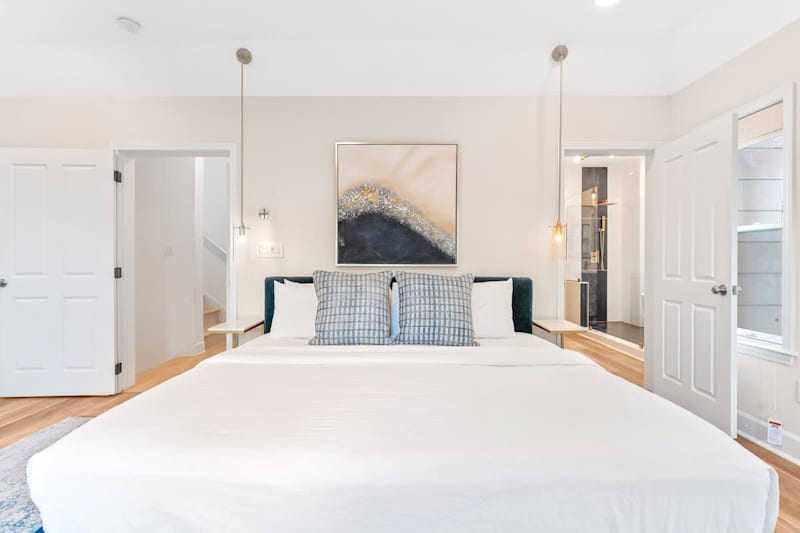 3rd floor primary bedroom with king size bed, private balcony, and ensuite bath.