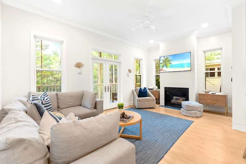 Spacious living room on the second floor with wraparound screened-in balcony.