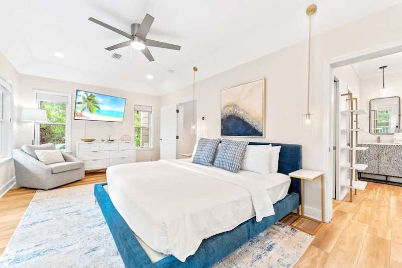 3rd floor primary bedroom with king size bed and private balcony.