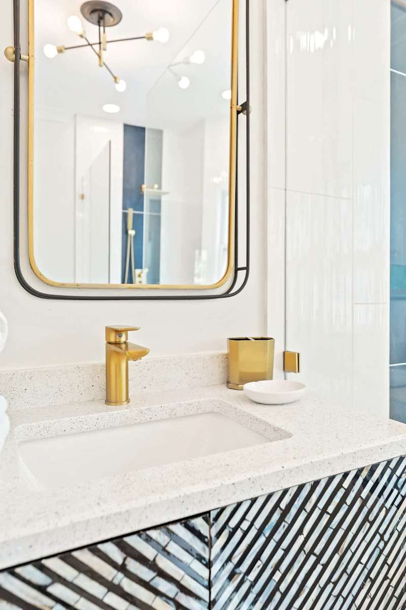 Luxurious primary bathroom with double rainfall showerheads and soaker tub.