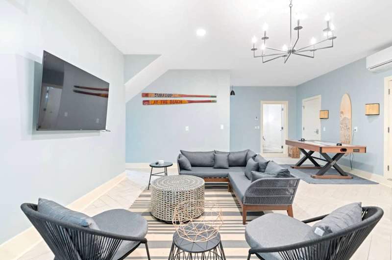 1st floor game room features a ping pong table, air hockey, fooseball, and lounge area.