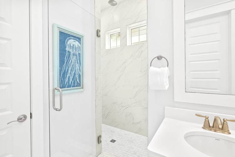 The primary bathroom features a large walk-in shower with rainfall showerhead!