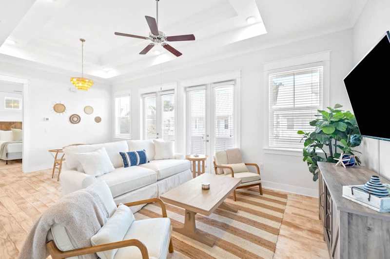 The living room features a smart TV & Queen sleeper sofa.