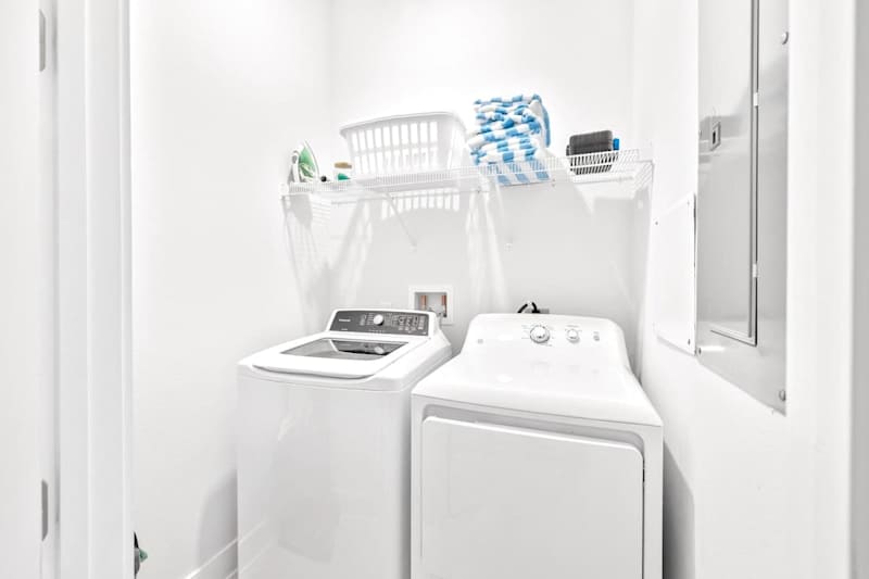 Laundry room features a full-size washer & dryer, iron, and pool towels!
