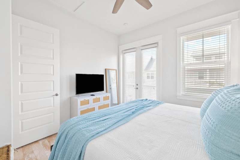 Guest bedroom features a smart TV.