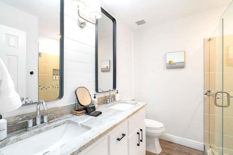 Primary bedroom bathroom features double vanities.