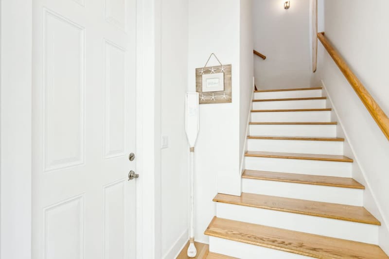 Entryway stairs to get up to living spaces from front door & garage.