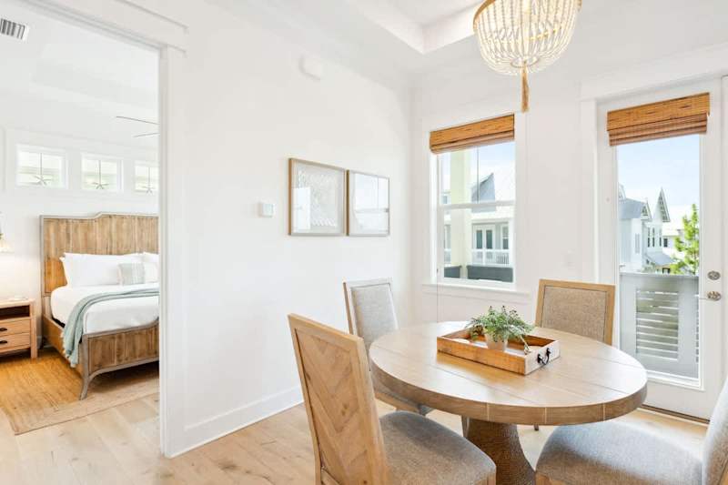 Dining room table has seating for 4, with an additional 4 counter stools at kitchen island.