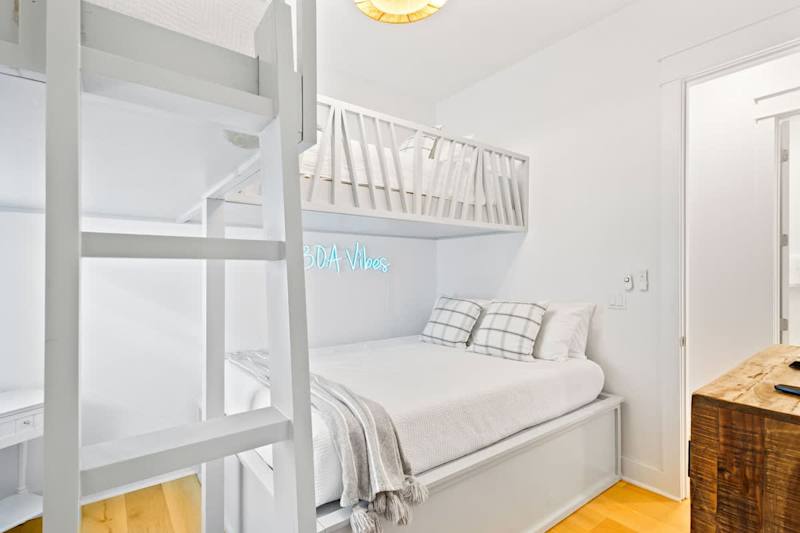 Bedroom #2 features (2) twin bunks over a queen bed and smart tv.