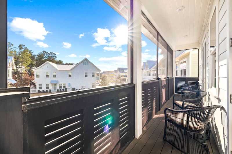 Screened-in balcony spans across the entire front of the home- perfect for watching sunrise and sunset!