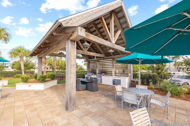 Beautiful gas grilling cabanas by pool.