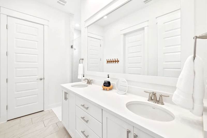 Primary bathroom features double vanities, walk-in closet, and rainfall shower.