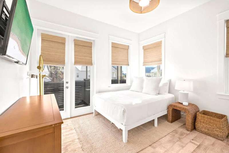 Guest bedroom features a queen bed and bunk beds.