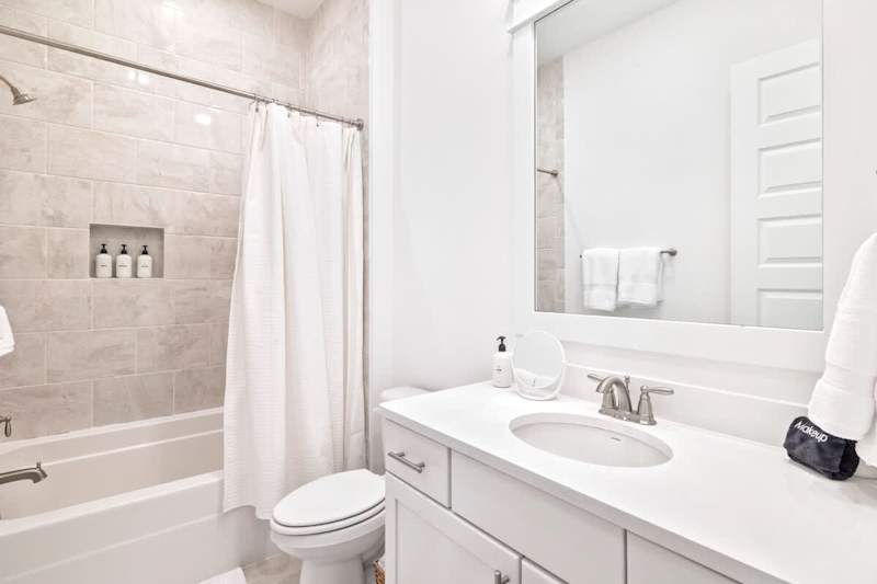 Hallway bathroom features a tub/shower combo!