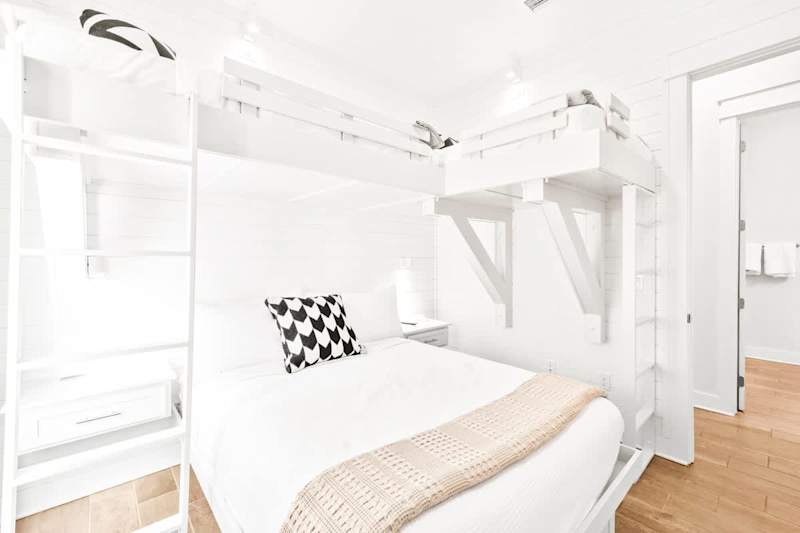 Bedroom features built-in nightstands and reading lights for each bed!