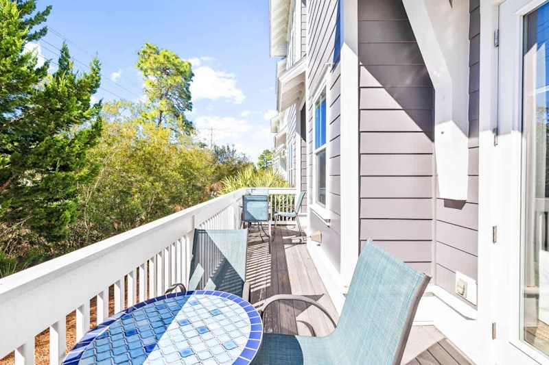 Patio space across back of home features two dining sets.