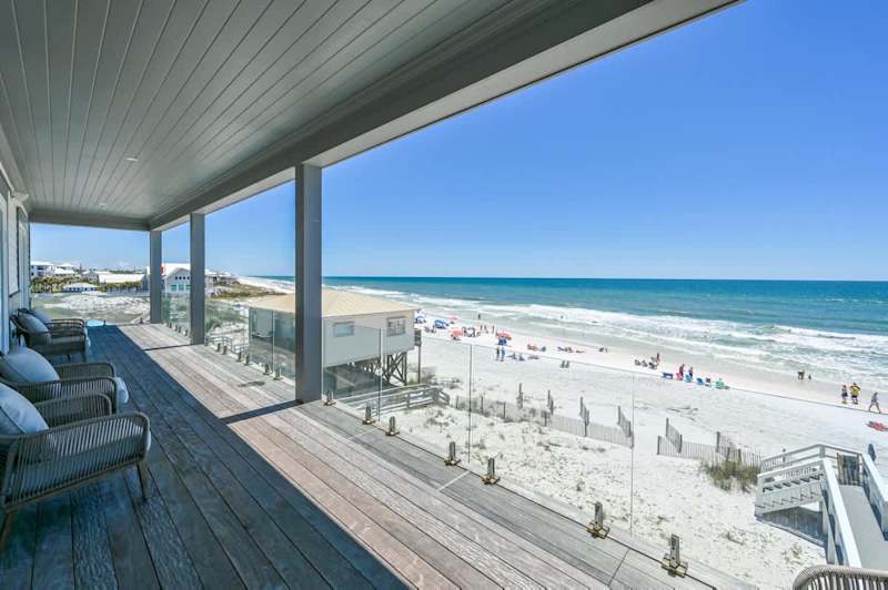 Balconies span across the back of the home on each level with stunning views of the Gulf.