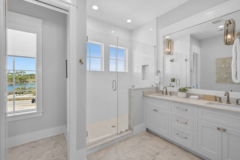Bedroom ensuite features a large walk-in shower and dual vanities.