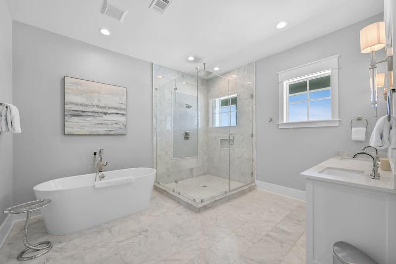Bedroom ensuite features a large walk-in shower and luxurious soaker tub.