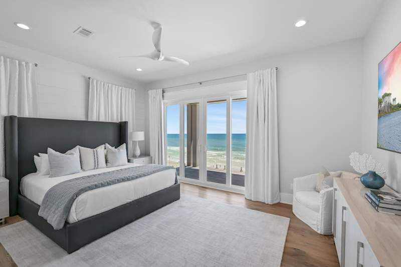 Second bedroom on fourth floor features a king bed, views of the gulf, and balcony.