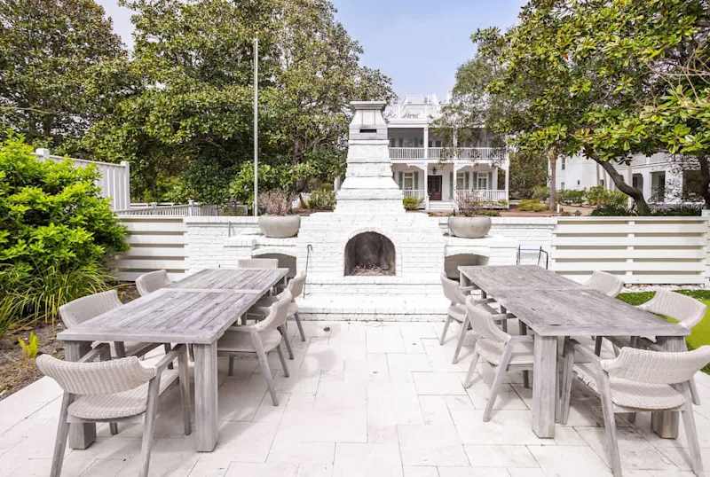 Plenty of outdoor dinner space in front of a wood fireplace.
