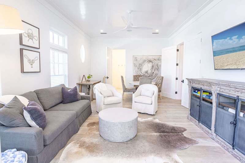 First floor living space with smart TV, Queen sleeper sofa, games, and bathroom.