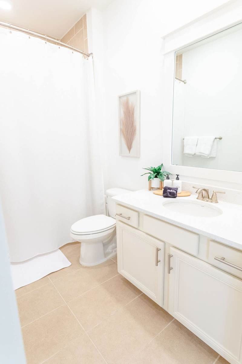 Guest bathroom has a shower/tub combo.