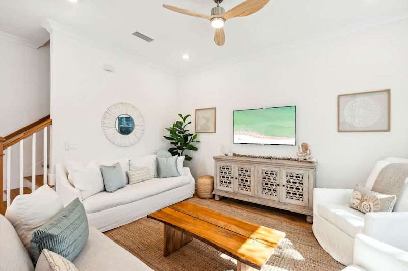 Living room space features plenty of seating for all and a smart tv to unwind in the evenings.