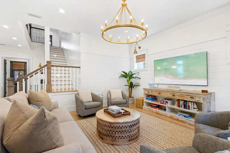 Living room space features modern coastal touches with a smart tv. Perfect place to unwind in the evenings.